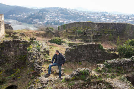 KUTAISI, GEORGIA - FEBRUARY 23, 2016: A man stands on the ruins of an ancient fortress.のeditorial素材