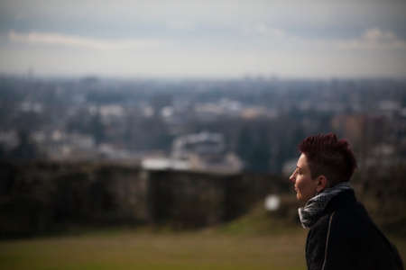 KUTAISI, GEORGIA - FEBRUARY 23, 2016: hipster girl tourist looks at the panorama of the city.のeditorial素材