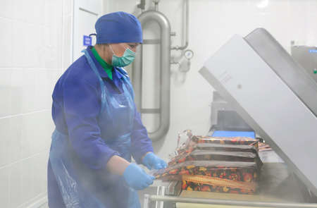 SHUCHIN, BELARUS - JANUARY 26, 2015.The woman is engaged in the packaging of cheese on a cheese factory.のeditorial素材