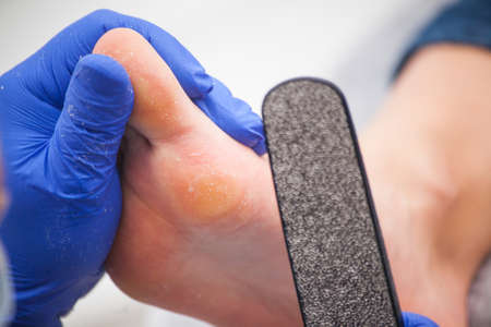 master pedicurist makes a pedicure female legs.の写真素材