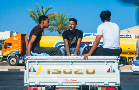 SHARM EL SHEIKH, EGYPT - JULY 9 2009. three workers traveling in carsのeditorial素材