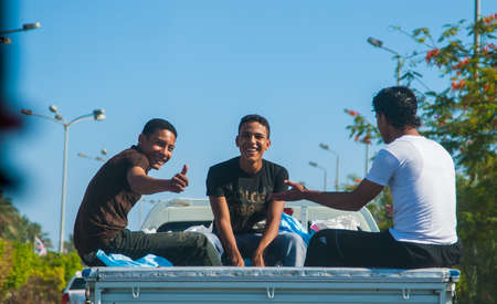 SHARM EL SHEIKH, EGYPT - JULY 9 2009. three workers traveling in carsのeditorial素材