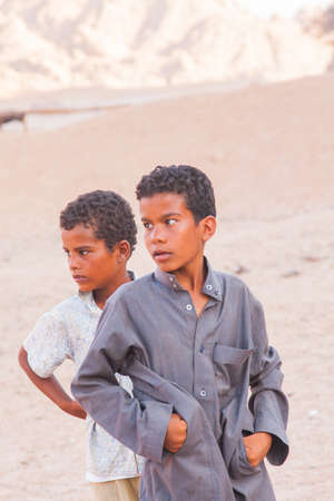 SHARM EL SHEIKH, EGYPT - JULY 9, 2009. Two sad child standing in the desert, and looking into the distance.のeditorial素材