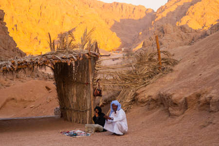 SHARM EL SHEIKH, EGYPT - JULY 9, 2009. Bedouin and Muslim woman selling goods to tourists in the desert.のeditorial素材