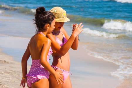 CONSTANTA, ROMANIA - AUGUST 21 2010. Children playing on the seashoreのeditorial素材