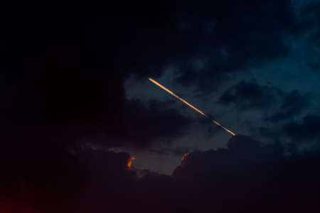 Skywriting from traces of aircraft engines with clouds.の写真素材