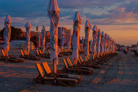 parasols on the beach by the sea. during dawn.の写真素材