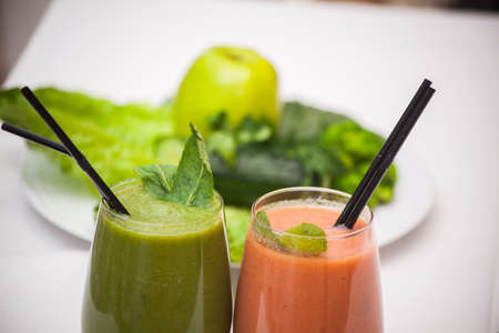 Healthy green and red smoothies and ingredients - superfoods, detox, diet, health, vegetarian food concept.の写真素材