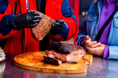 Man and woman examine meat steaks. High quality photoの写真素材