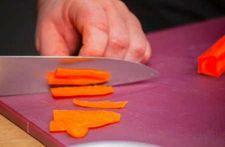 slicing fresh carrots in the kitchen close-up. High quality photoの写真素材