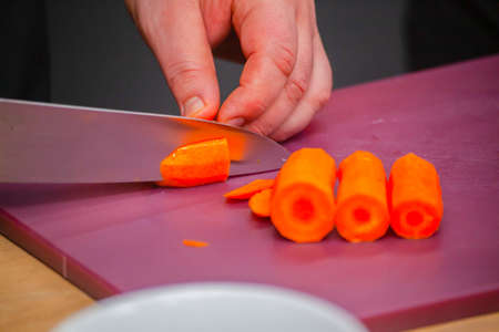 slicing fresh carrots in the kitchen close-up. High quality photo