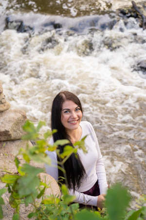 beautiful young girl posing near the riverの写真素材