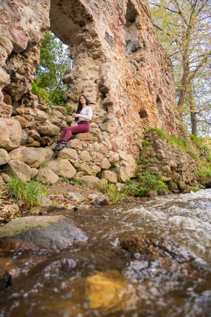beautiful young girl posing near the riverの写真素材