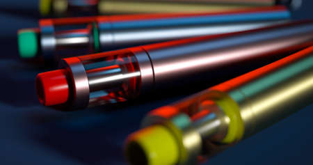 e-cigs of green red and yellow colours vaping devices on the black backgroundの写真素材