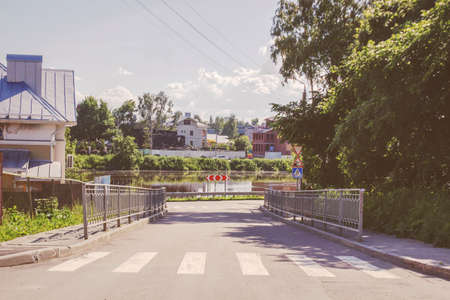 old town street road and a river in summer vologda, russiaの写真素材