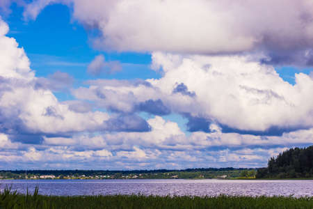 Blue summer sky with massive clouds over Lakeの写真素材