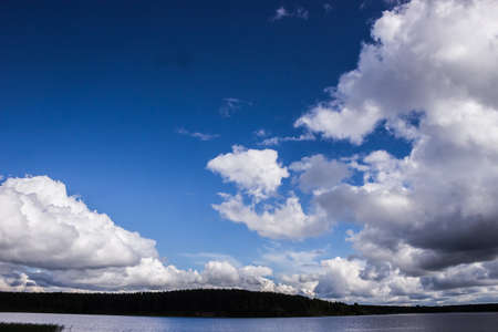 Blue summer sky with massive clouds over Lakeの写真素材