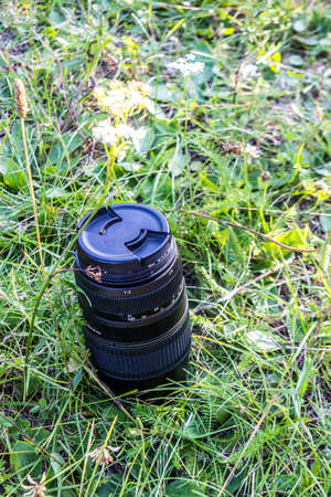 a telephoto lens standing in green grassの写真素材