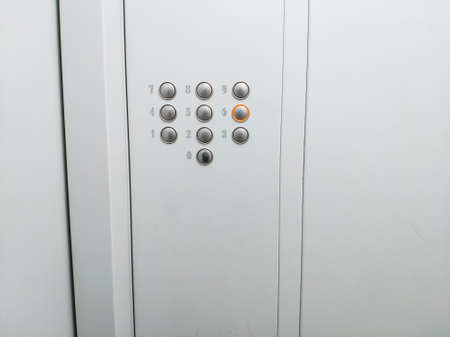 Elevator buttons panel with 6th floor selected metal walls