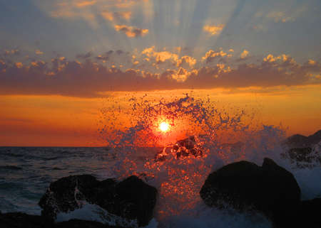 Sunset view through the sea wave dropsの写真素材