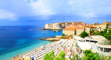 Tourists enjoying on sandy beach Banje, near Dubrovnik old town in Croatiaのeditorial素材