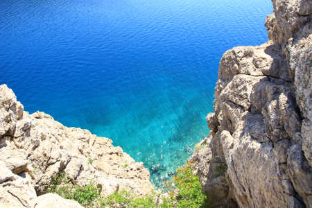 Clear blue sea and rocky coast near Karlobag, touristic place in Croatiaの写真素材