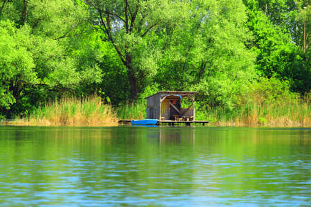 Small fishing house on lakeの写真素材
