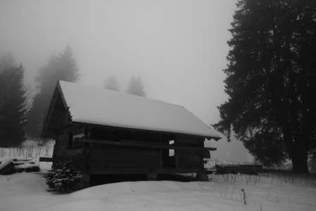 Old abandoned house covered with snowの写真素材