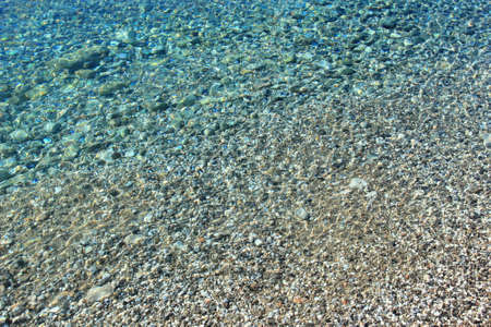 Clear transparent sea with rocky pebbles bottom. Adriatic sea in town Senjl, Croatia.