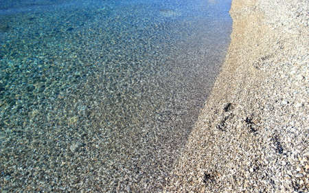 Clear transparent sea with rocky pebbles bottom on the beach in town Senj, Adriatic sea, Croatiaの写真素材