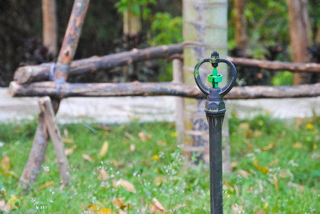 sprinkler watering tool in gardenの写真素材