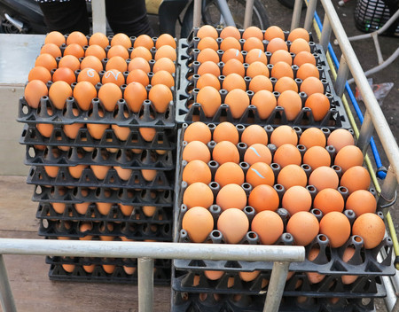 Brown chicken eggs in a package on wood background