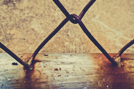 Close up of rusty steel wire mesh fence vintage toneの写真素材