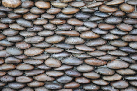 background of small gravel stone texture.Sea stones wall abstract background.の写真素材