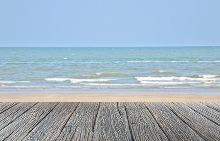 wood floor on sand beach with sea and blue sky beautiful natural tropical seaの写真素材