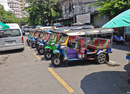 BANGKOK, THAILAND - OCTOBER 10, 2017:The three wheeled tuk tuk taxi wait passenger on a street in the Thai capital on October 10, 2017 in Bangkok, Thailand. Tuk tuks are commonly used in transporting people.のeditorial素材