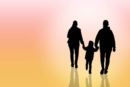 The silhouette of a happy family is father, mother and son walking in sunset.の写真素材