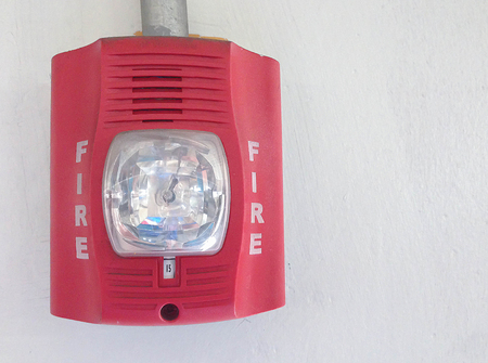 fire alarm with strobe light on white backgroundの写真素材