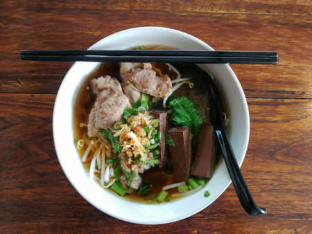 Duck noodle in a white bowl on wood table this is delicious local cuisine food of thailand or asia...