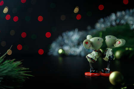 A couple of mice toy, symbol of Chinese happy new 2020 on dark background table and new year pine. New Year 's 2020 Symbol. Christmas rat or mouse concept. Top view. Place for text.の写真素材