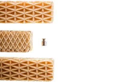 Three sweet rectangular shaped waffles and 2 grams metal weight or dumbbell isolated on white background. Fat unhealthy tasty food, diet, nutrition, overweight concept.の写真素材