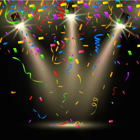 Colorful confetti on dark backgroundの写真素材