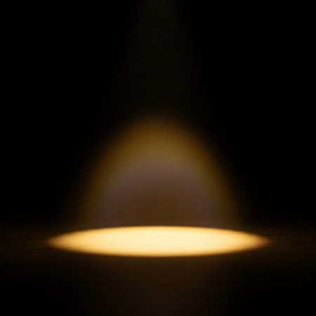 Spotlight on a black background. Spotlight shines through the darkness.の素材