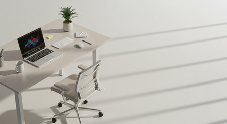 A top-down view showcases a minimalist workspace. A laptop sits open on a white desk, alongside a small potted plant and writing utensils. A modern, ergonomic chair is positioned nearby. The scene is bathed in soft, natural light, casting striped shadows across the white floor.の素材