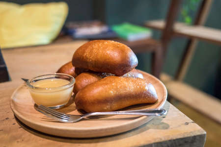 Bread Butter in the morning on a wooden table.