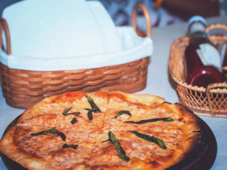 Cheese pizza on wooden cutting board, closeup