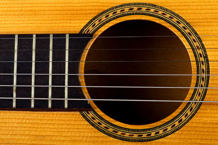 Closeup of an old orange guitarの写真素材