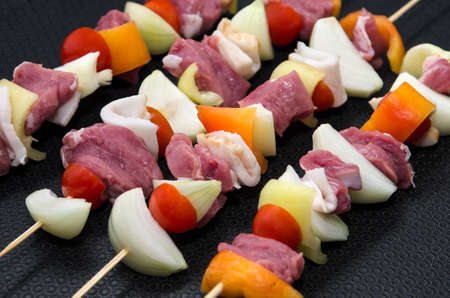 Closeup photo with meat skewers in frying panの写真素材
