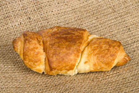 Closeup photo with croissant on burlapの写真素材