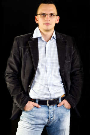 Business man posing in studio isolated on blackの写真素材